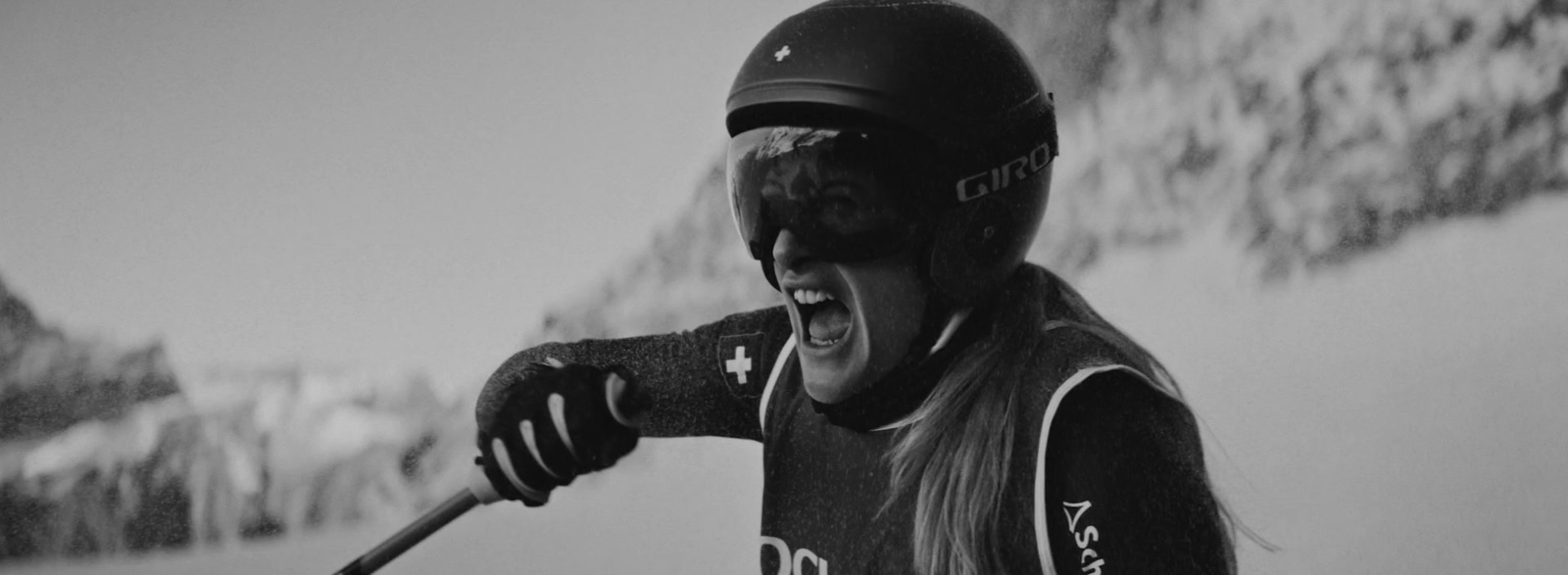 a woman wearing a helmet and holding a ski pole