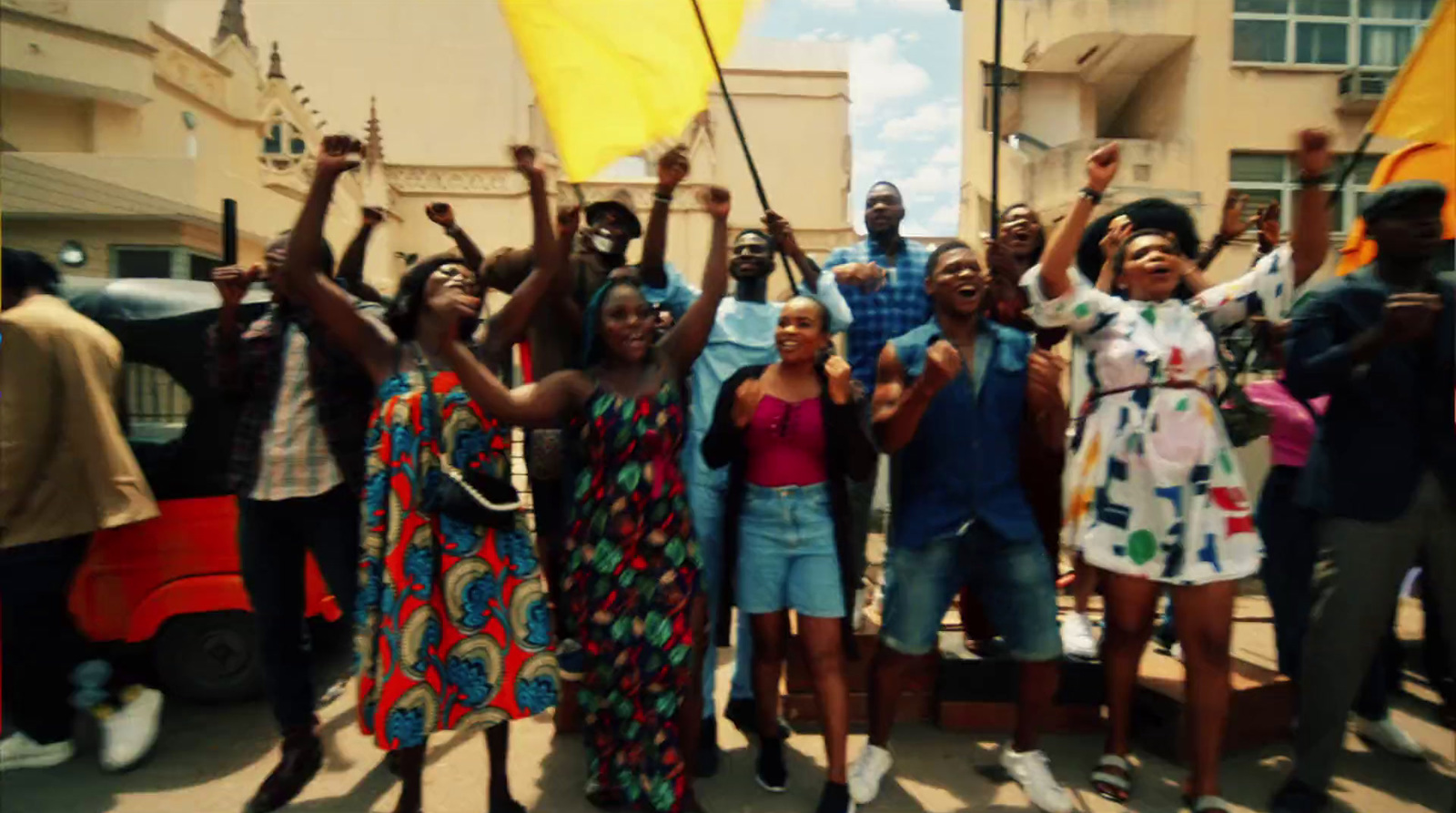 a group of people holding up yellow flags