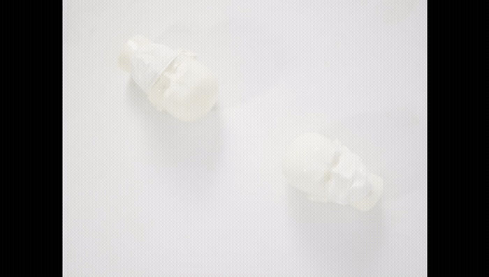 a couple of pieces of white plastic sitting on top of a table