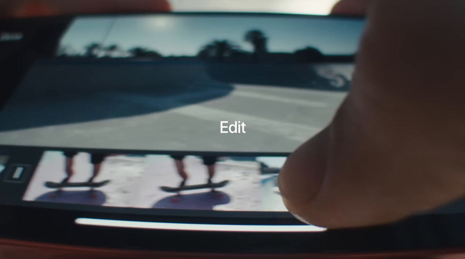 a person taking a picture of a skateboarder on a cell phone