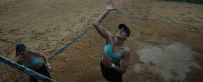 a couple of women playing a game of volleyball