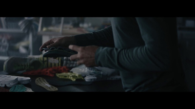 a person standing at a table with a pair of scissors