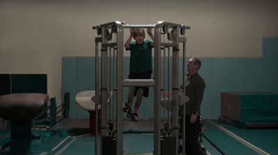 a man standing on a machine in a gym