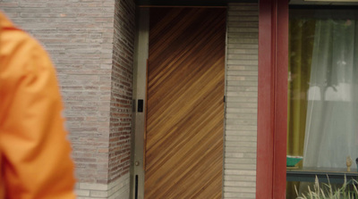 a person standing in front of a brick building