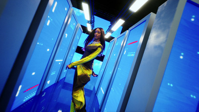 a woman in a yellow and black dress standing in a room