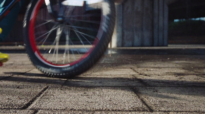 a close up of a bike tire on a sidewalk