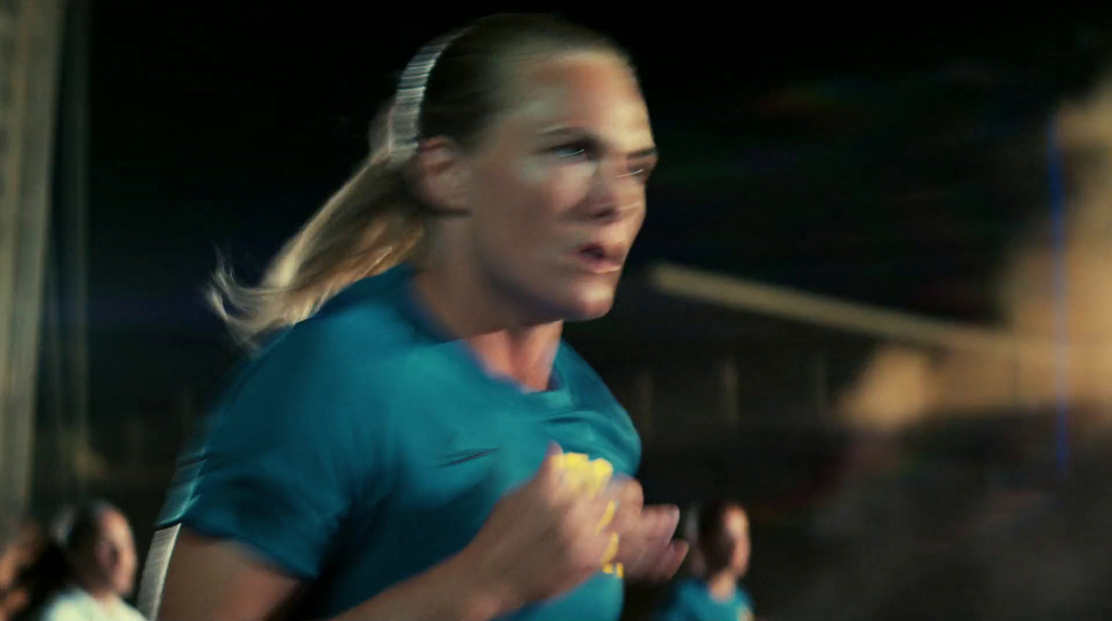 a woman in a blue shirt is running