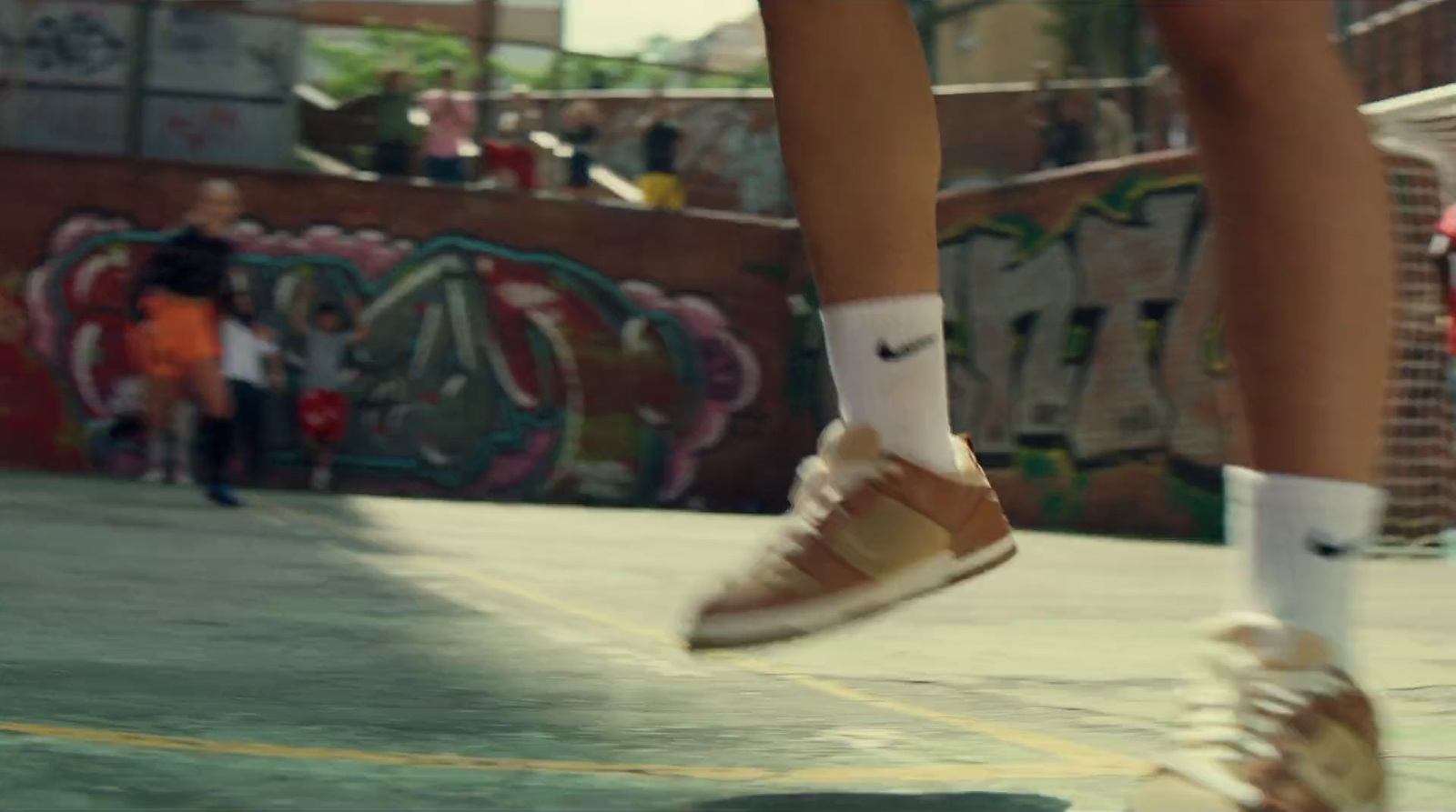 a person in white socks and tan shoes is doing a trick on a skateboard