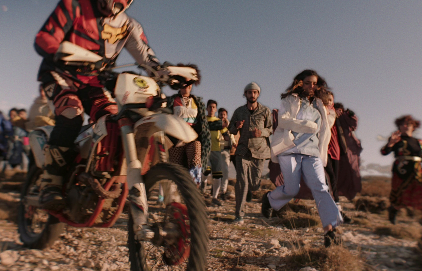 a man riding a dirt bike on top of a dirt field