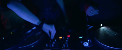 a dj mixing music in a dark room