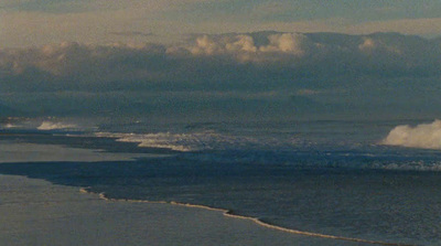 a man riding a surfboard on top of a wave in the ocean