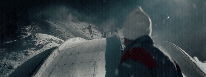 a person walking up a snow covered hill