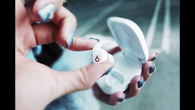 a woman holding a nintendo wii game controller