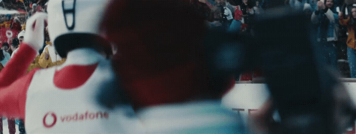 a crowd of people standing around a giant red and white object