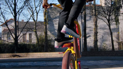 a person riding a skate board on a sidewalk