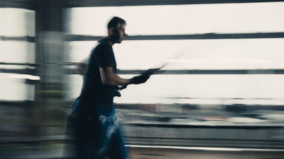 a blurry photo of a man walking down a street