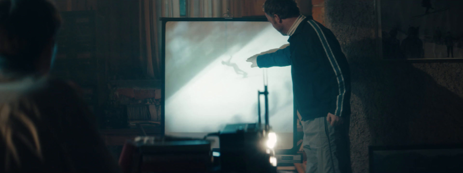 a man standing in front of a tv in a living room