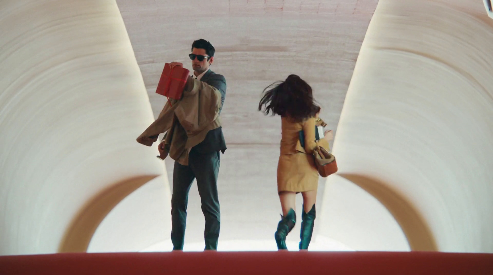 a man and a woman walking through a tunnel