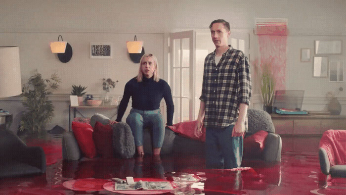 a man and a woman standing in a flooded living room