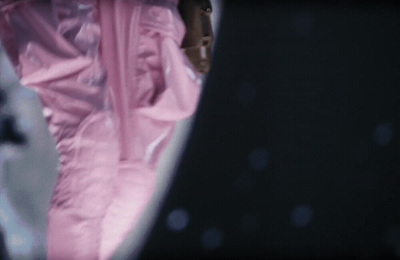 a close up of a person in a pink suit