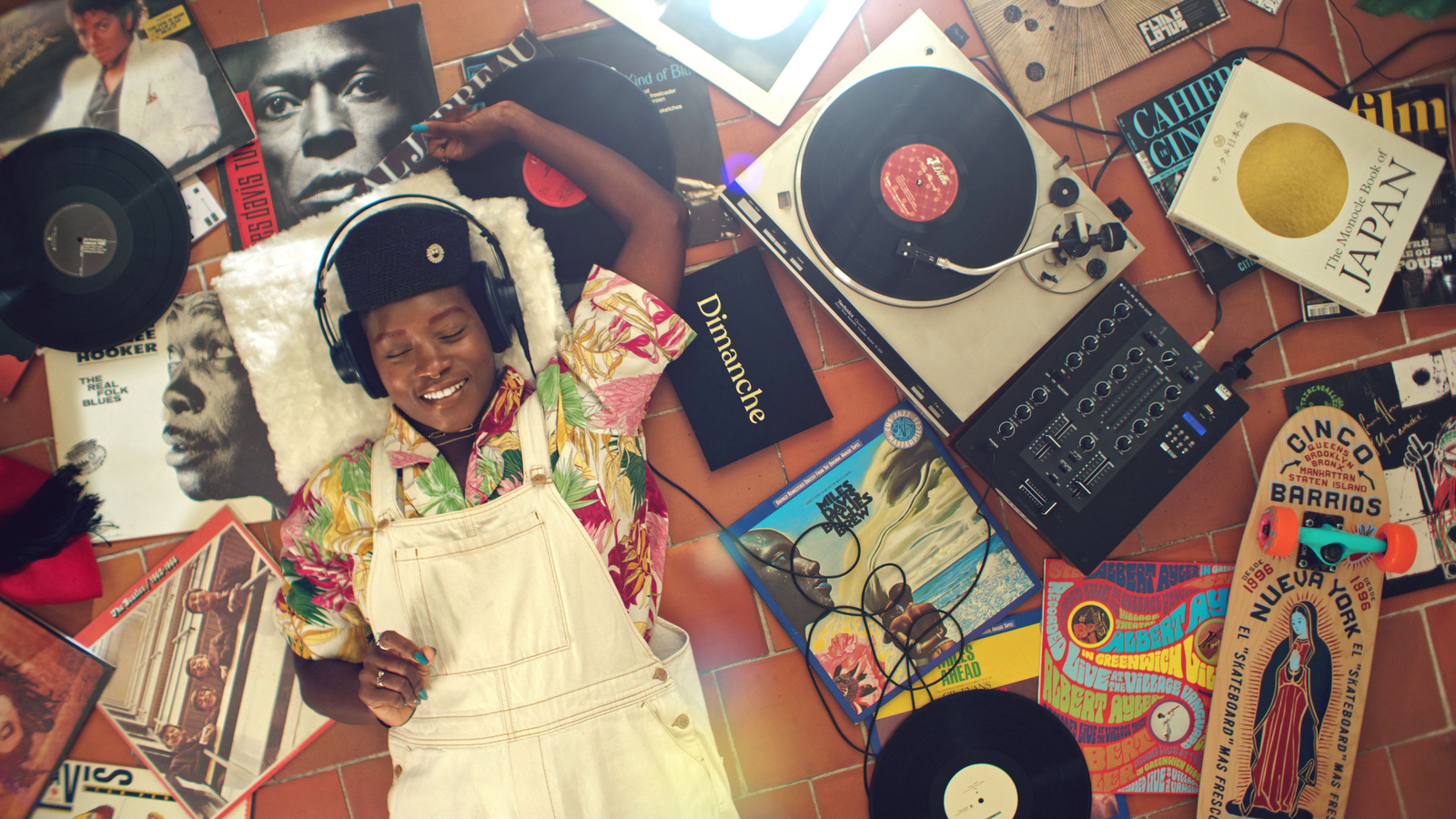 a woman in a white apron surrounded by records