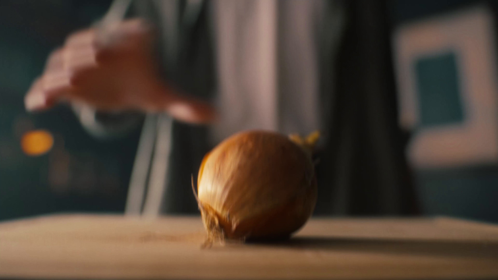 a onion being peeled on a cutting board