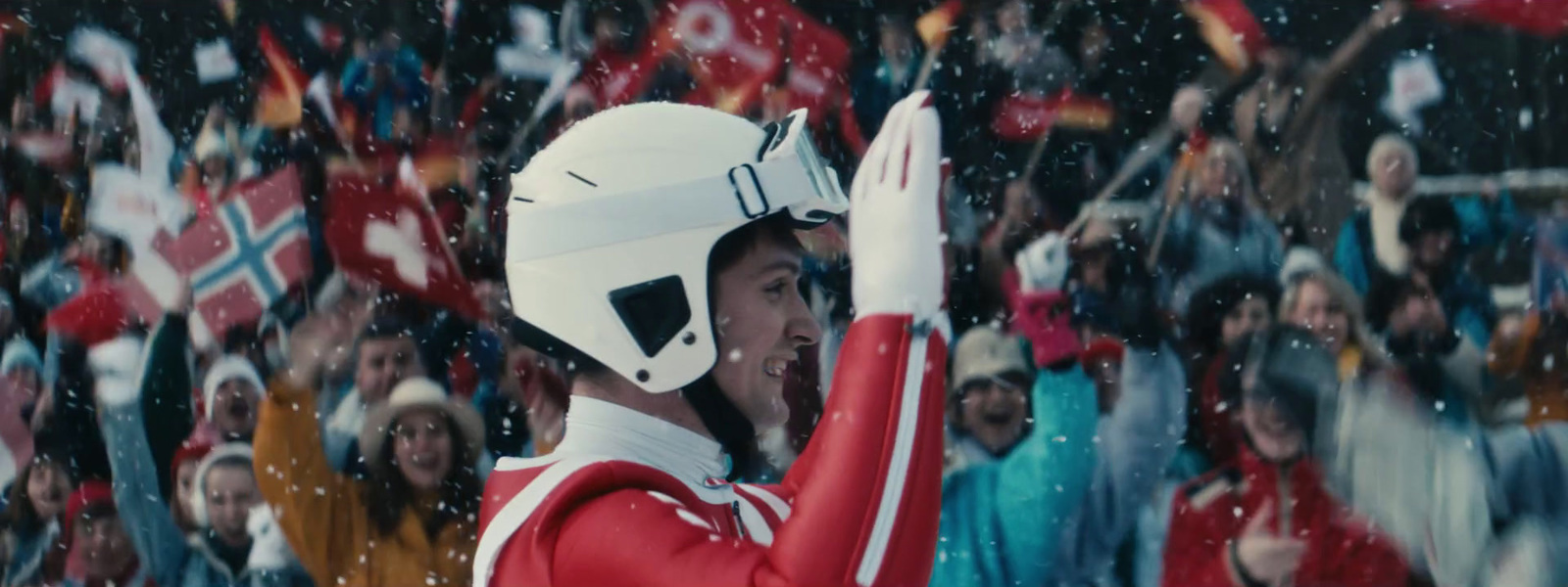 a man in a red and white uniform waves to a crowd