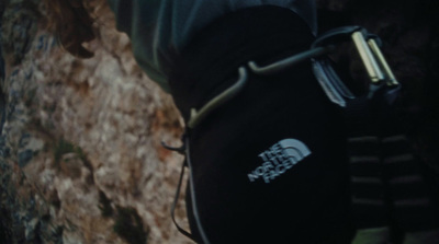 the north face glove is attached to a rock