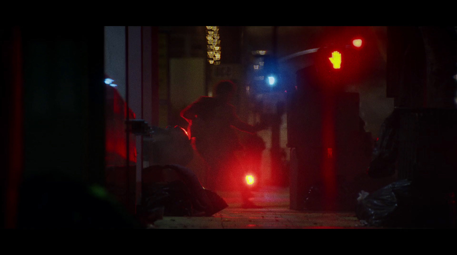 a person walking down a street at night