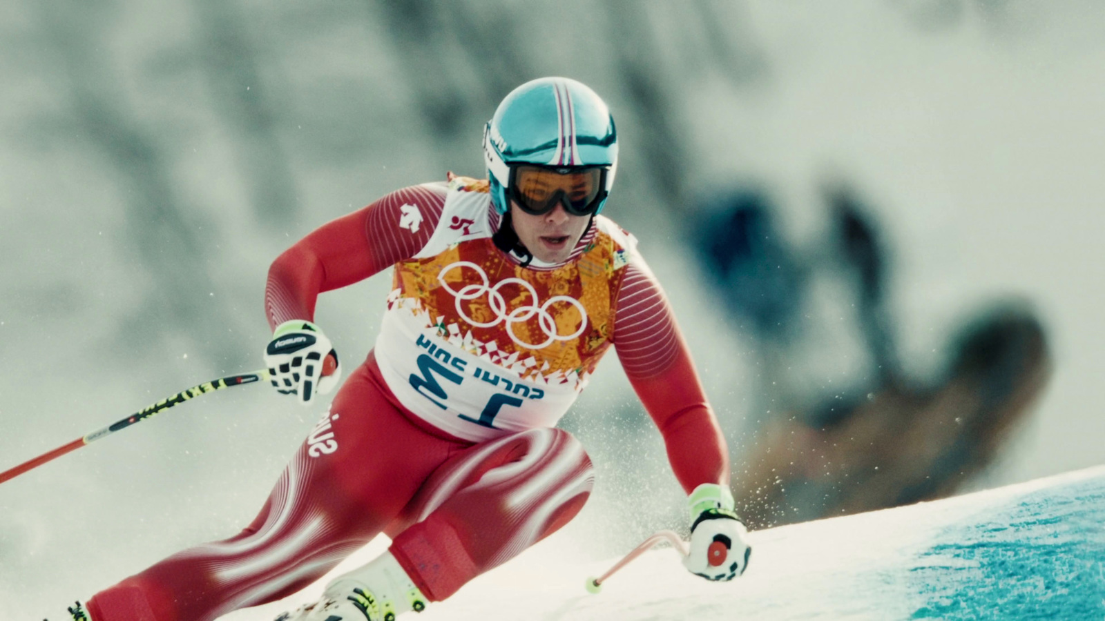 a man riding skis down a snow covered slope