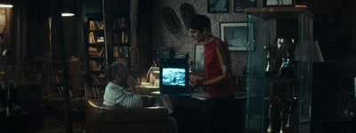 a man sitting in a chair in front of a computer monitor