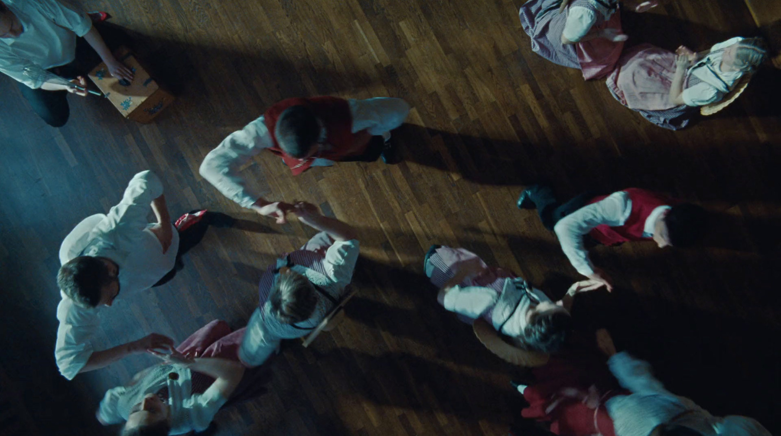 a group of people standing on top of a wooden floor