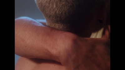 a close up of a person brushing his hair