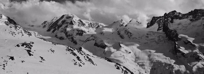 a black and white photo of snow covered mountains