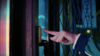 a person pointing at a door with a finger on it