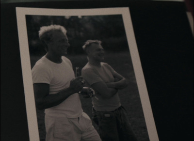 a black and white photo of two men holding tennis rackets