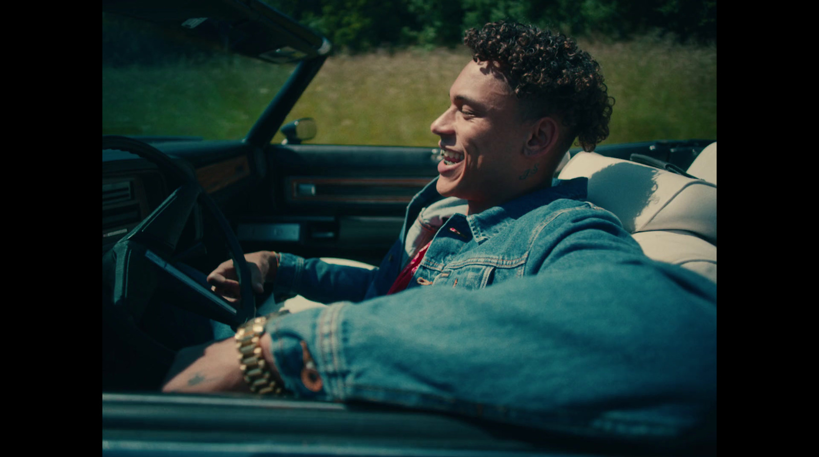 a man sitting in the drivers seat of a car