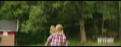 a blurry photo of two people walking in a field