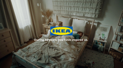 a child laying in a bed with the ike logo on it