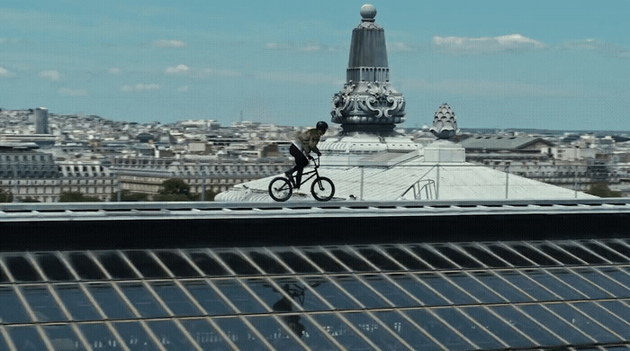 a person riding a bike on top of a roof