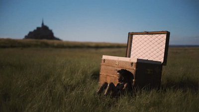 an open suitcase sitting in the middle of a field