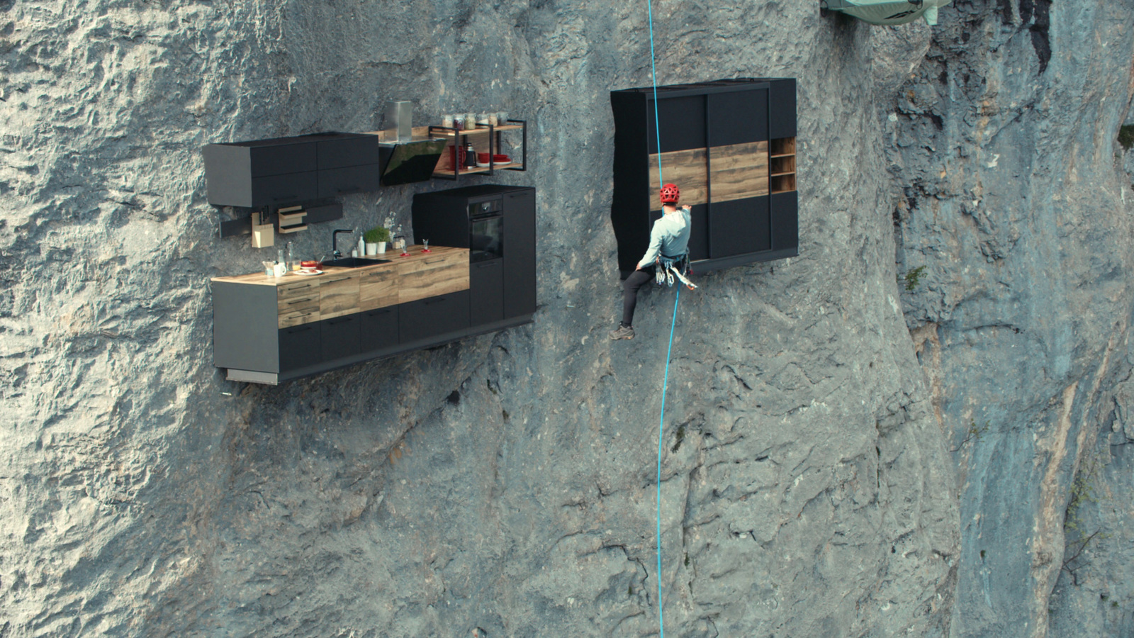 a man climbing up the side of a cliff