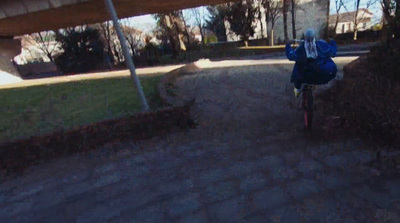 a person riding a bike down a dirt road