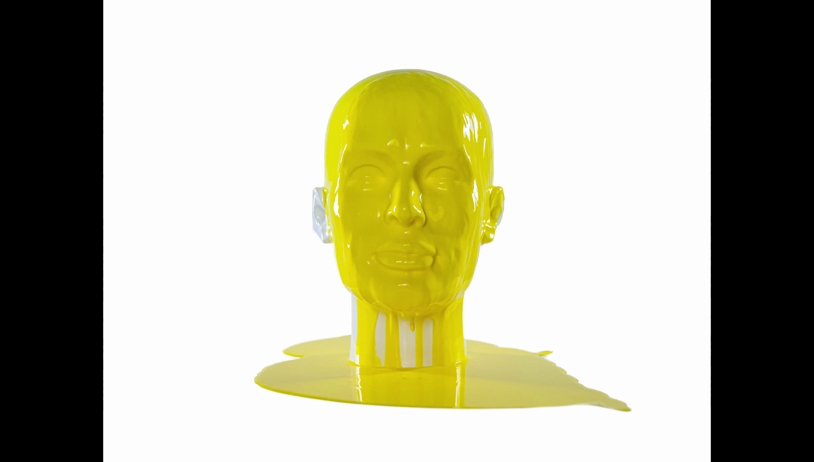 a yellow sculpture of a man's head is shown