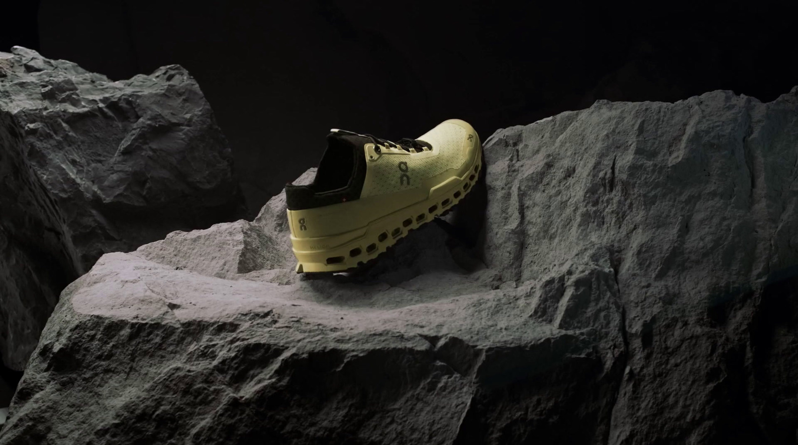 a pair of yellow shoes sitting on top of a rock