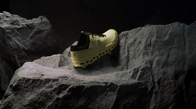 a pair of yellow shoes sitting on top of a rock