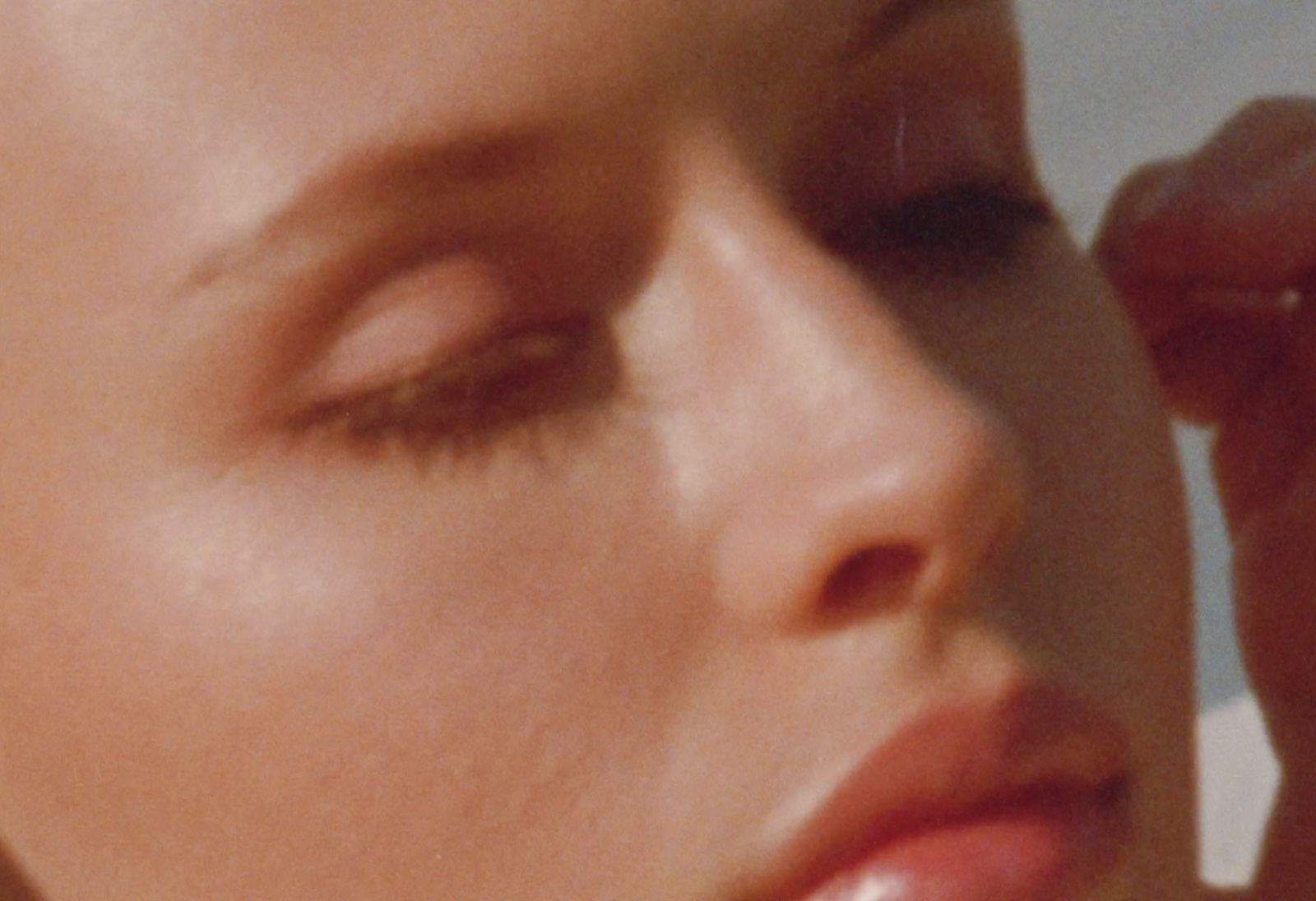 a close up of a woman with her eyes closed