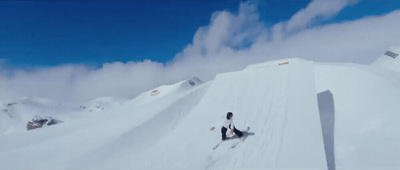 a person on skis going down a snowy hill