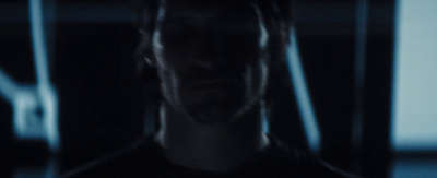 a man standing in a dark room with a blurry background