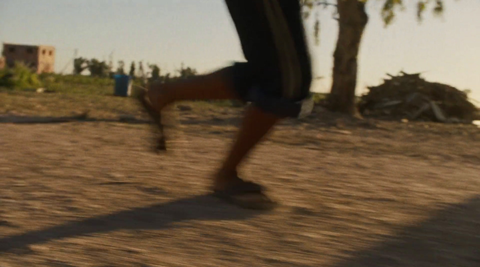 a blurry photo of a person running on a dirt road